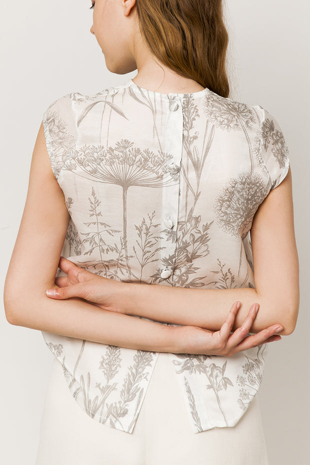 Model in sleeveless silk & cotton top  - back view