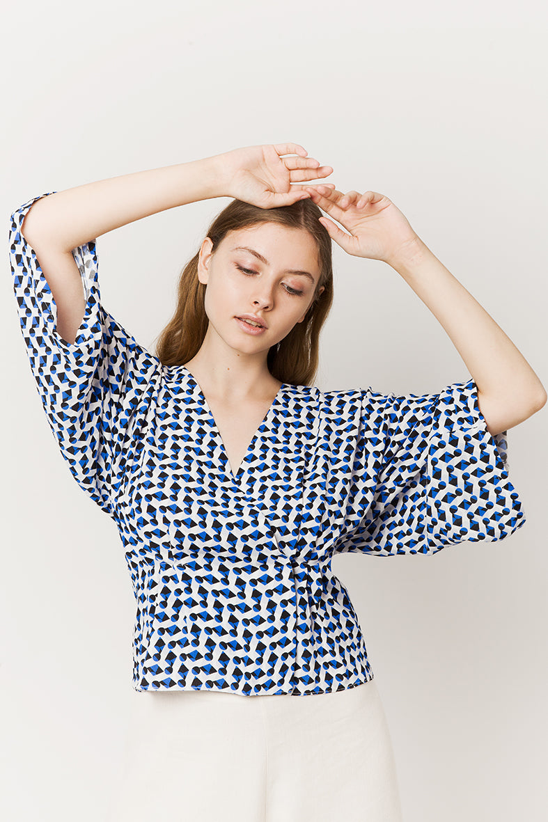 Model in blue geometric wrapover kimono top