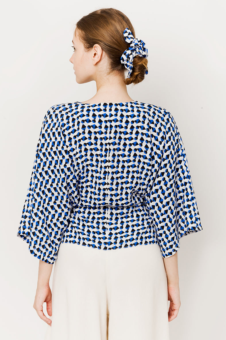 Model in blue geometric wrapover kimono top - back view