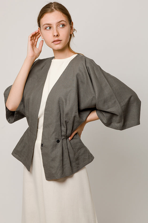 Model in open Gray wrapover kimono top and white top and pants