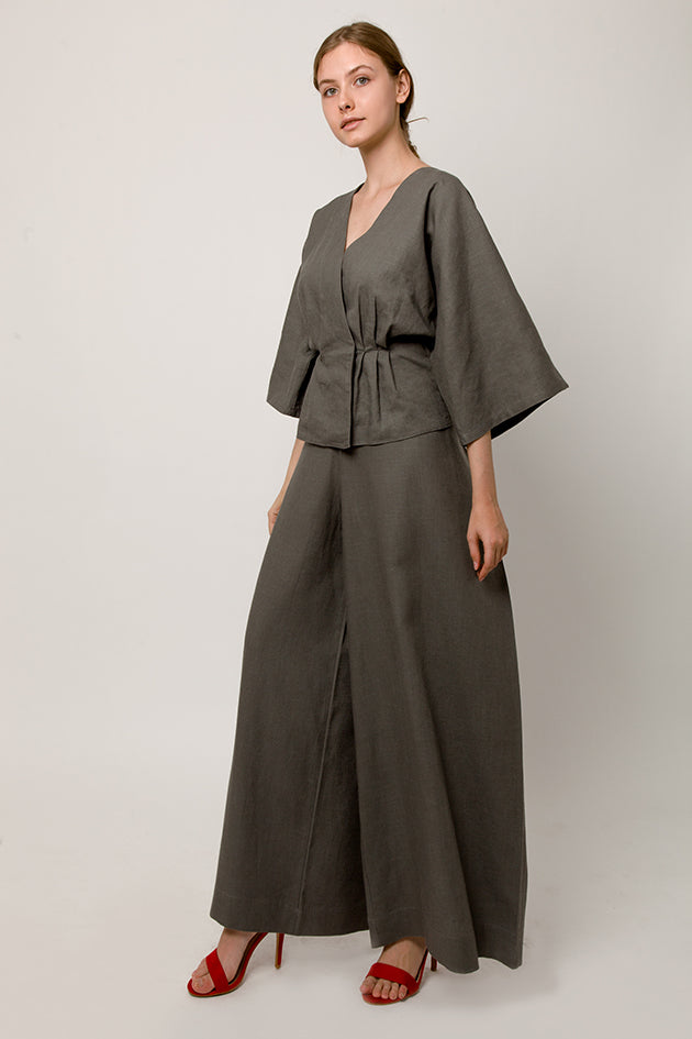 Model in gray wrap pants with back knot