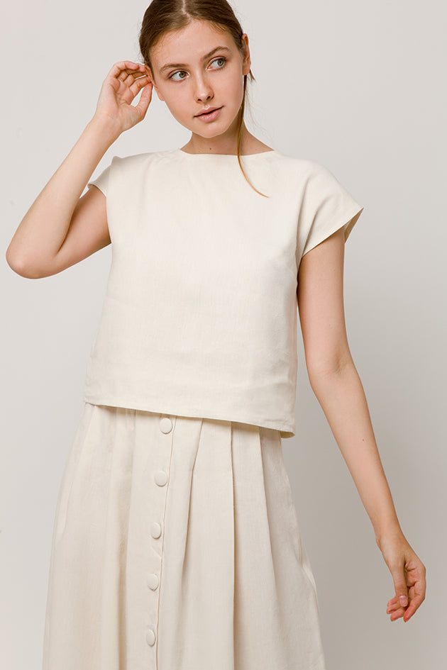white skirt with hand-crafted buttons