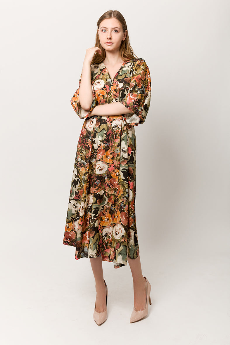 Model with long wrap tiche design summer dress with flower print and a belt 
