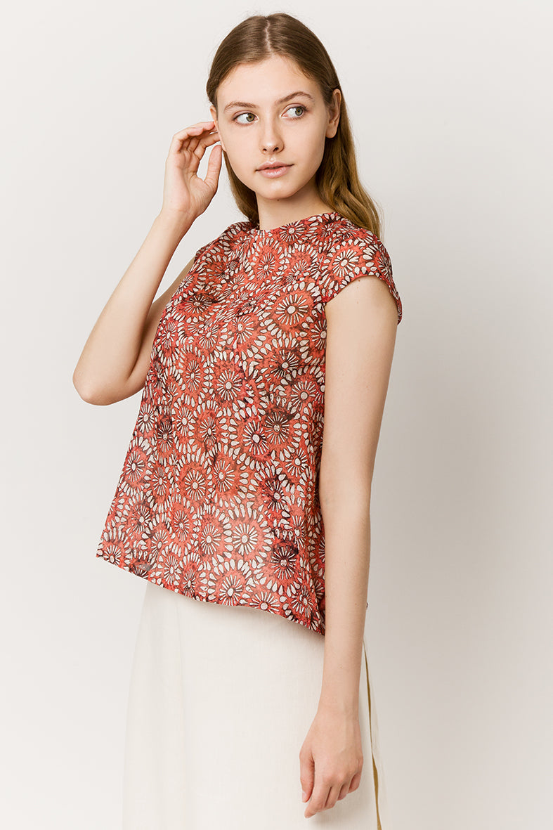 Model in red light cotton top with flowers - side look